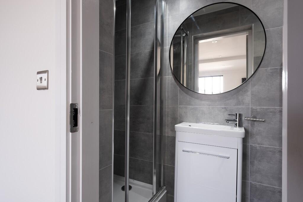 Well-maintained bathroom with a shower enclosur...