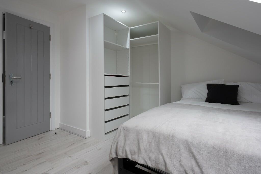 A cozy and well-maintained bedroom featuring a ...