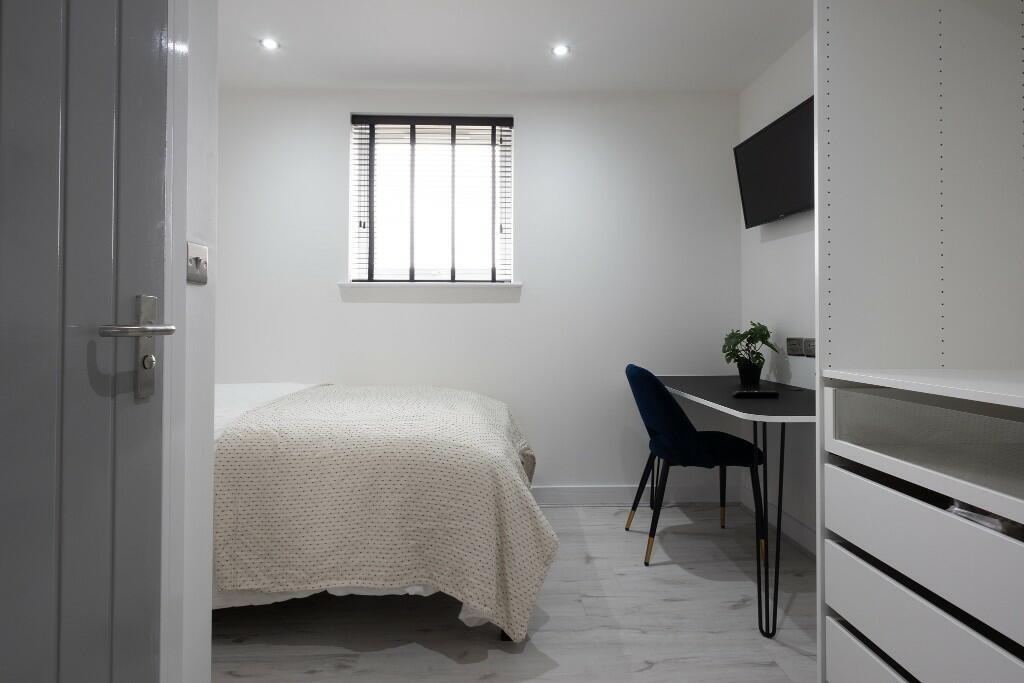A bright, well-maintained bedroom featuring a c...