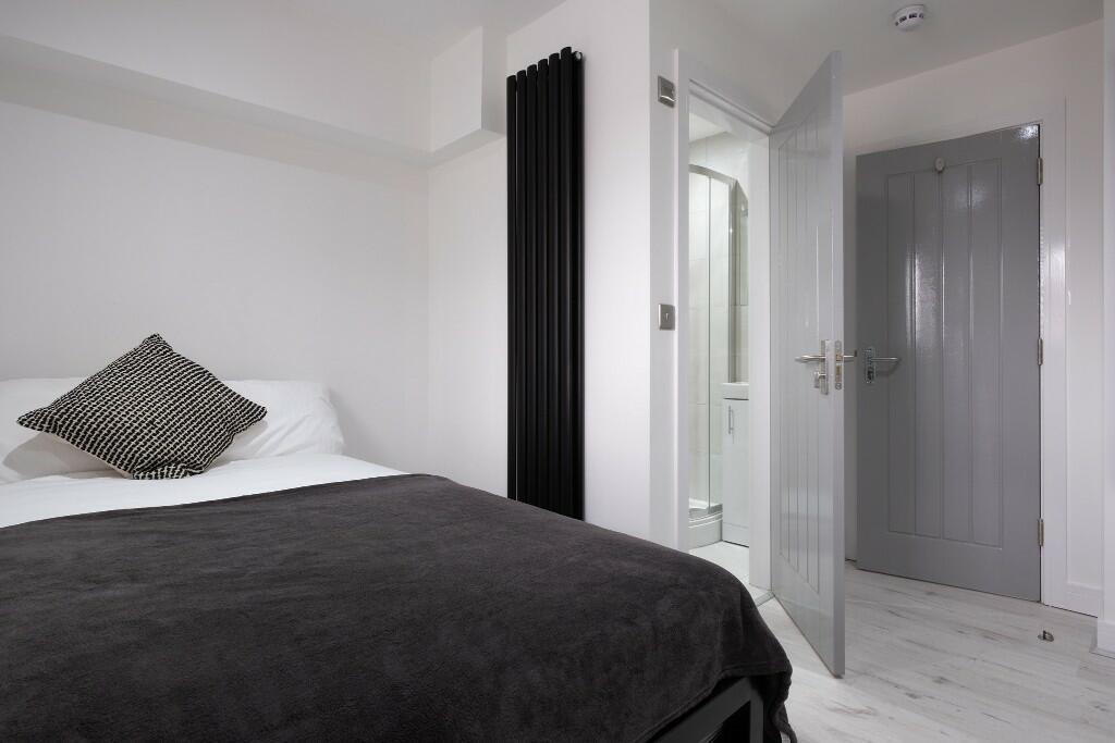 A clean and modern bedroom featuring a comforta...