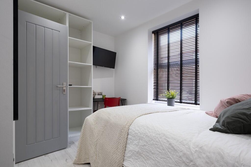 A bright and inviting double bedroom featuring ...