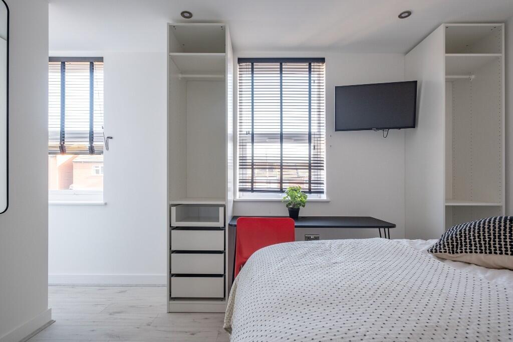 A bright and modern master bedroom featuring a ...