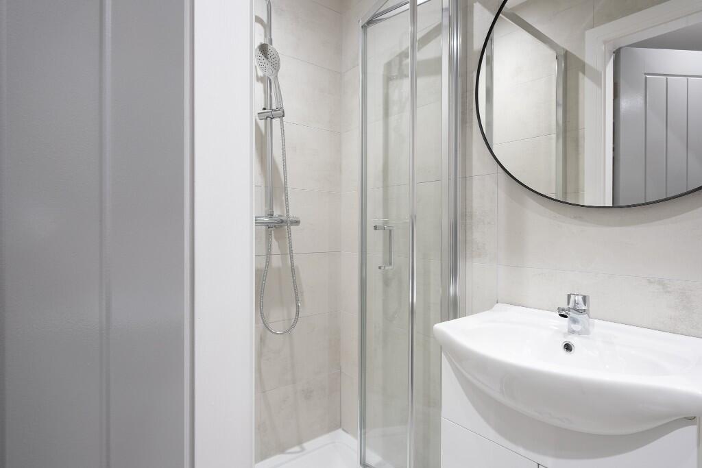 A modern, clean bathroom featuring a spacious s...