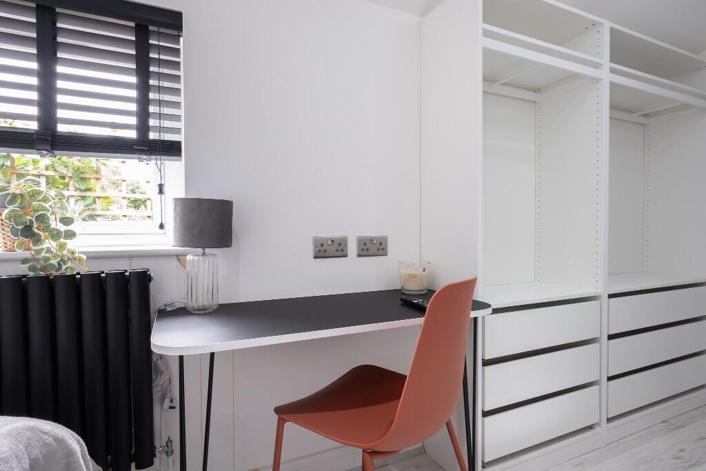 A bright and tidy study desk area with a window...