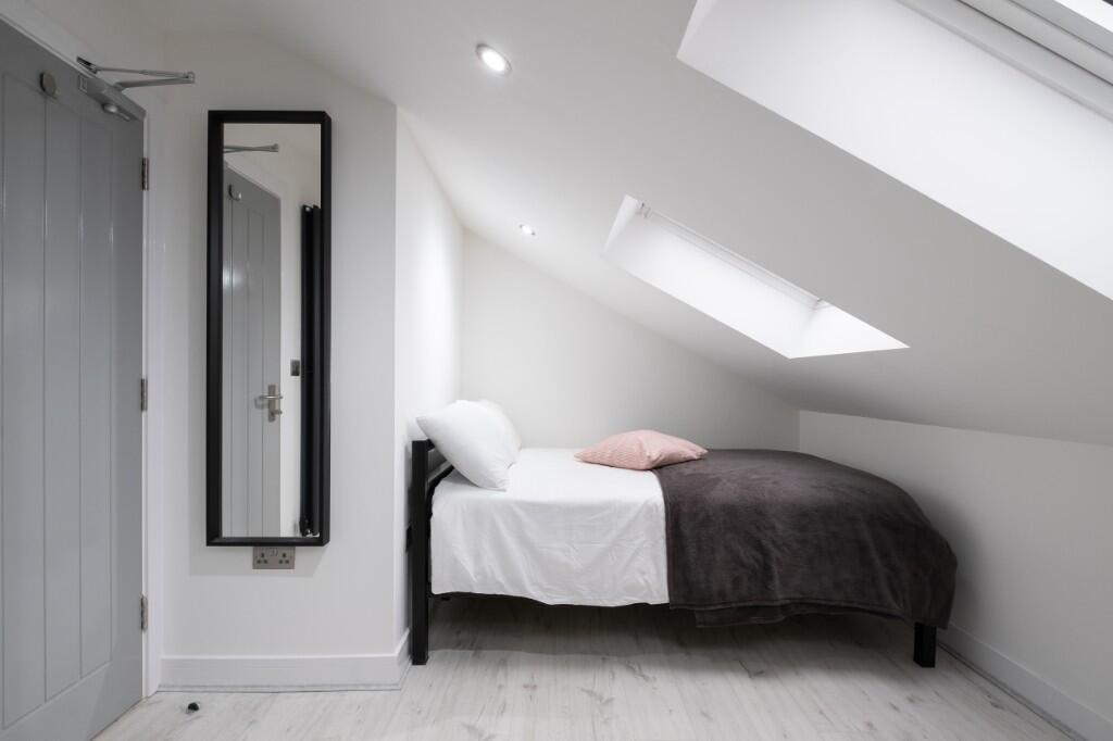 A modern and bright master bedroom featuring a ...