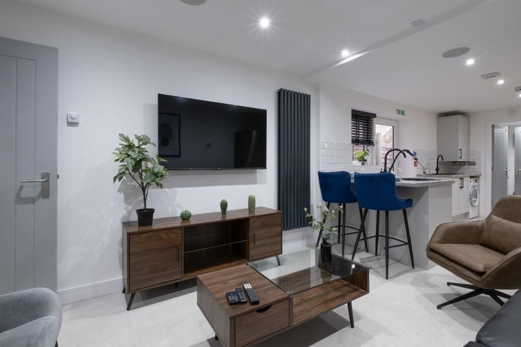 Modern and inviting living room featuring a sle...