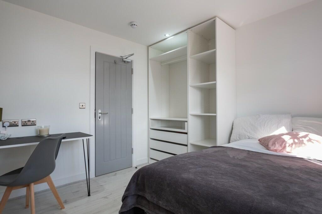 A modern, well-maintained bedroom featuring a c...
