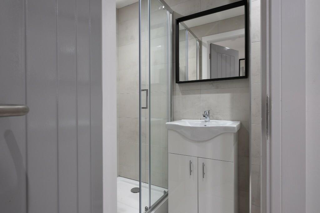 A clean, well-maintained bathroom featuring a w...
