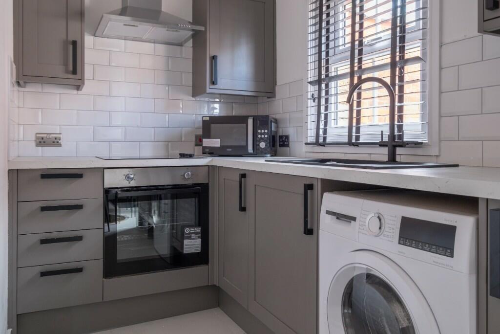 A modern and well-maintained kitchen with clean...