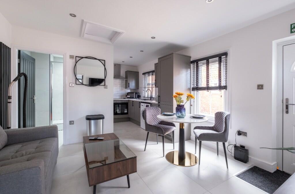 A modern, spacious living room with large windo...