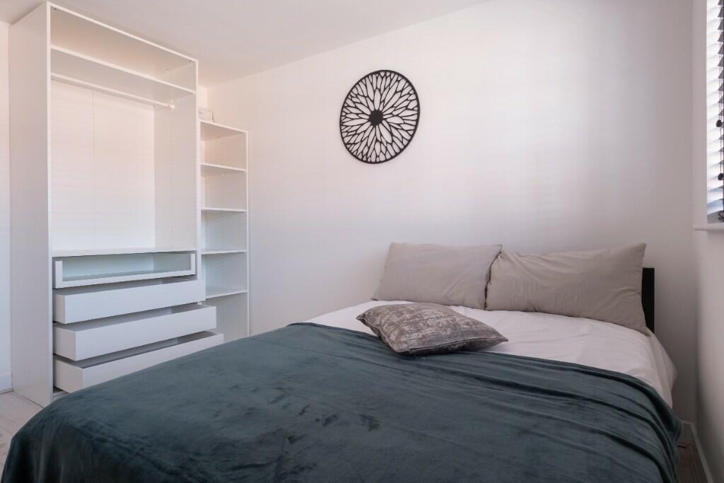 A bright and inviting double bedroom featuring ...