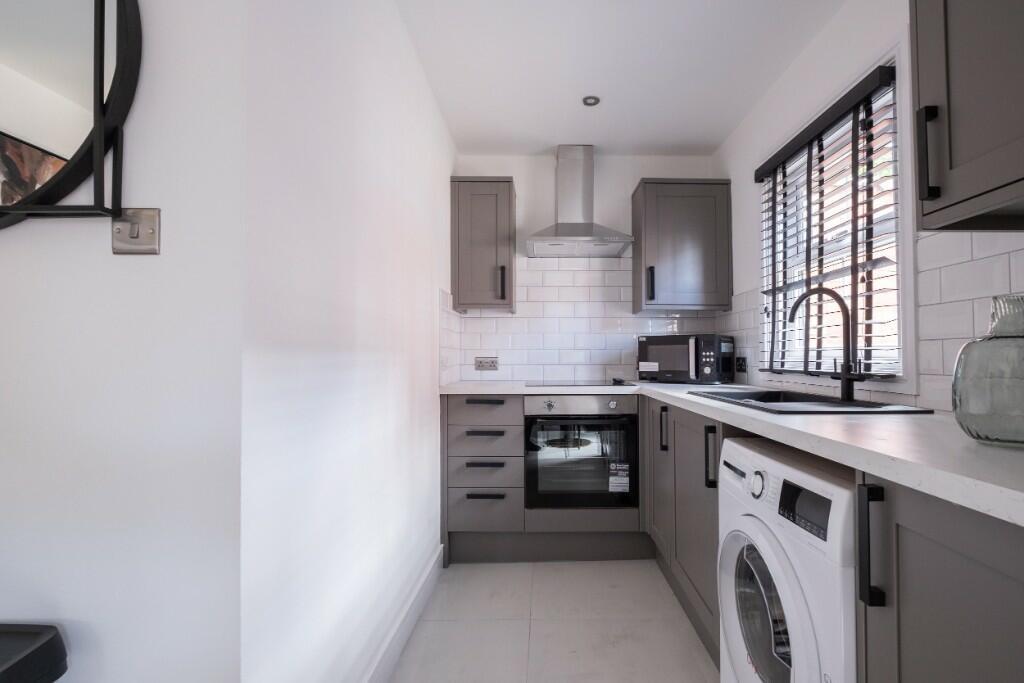 A modern, bright kitchen with ample counter spa...