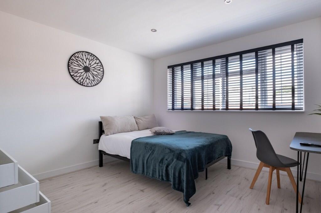 A bright and spacious master bedroom featuring ...