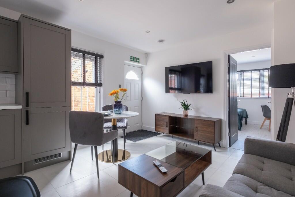 A modern, well-lit living room with comfortable...