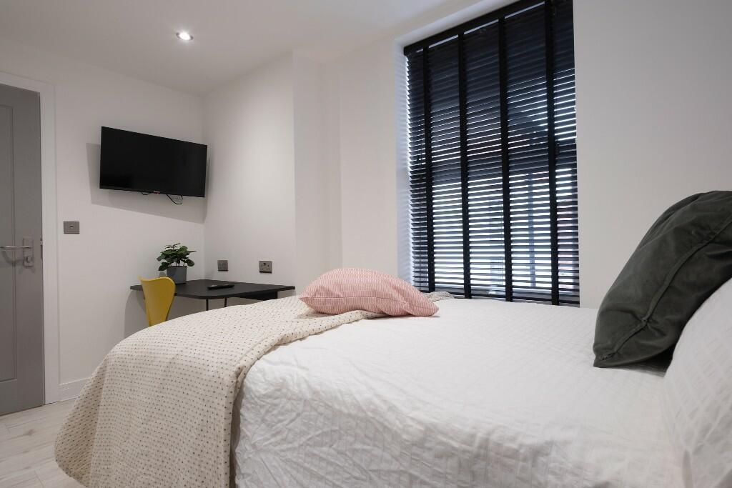 Bright and spacious master bedroom featuring a ...