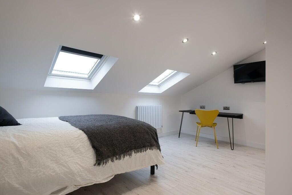 A modern, well-lit living room with spaciousnes...