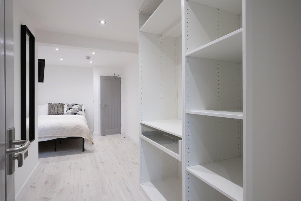 A bright and modern bedroom featuring a comfort...