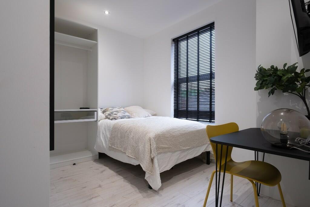 Bright and clean bedroom with a comfortable dou...