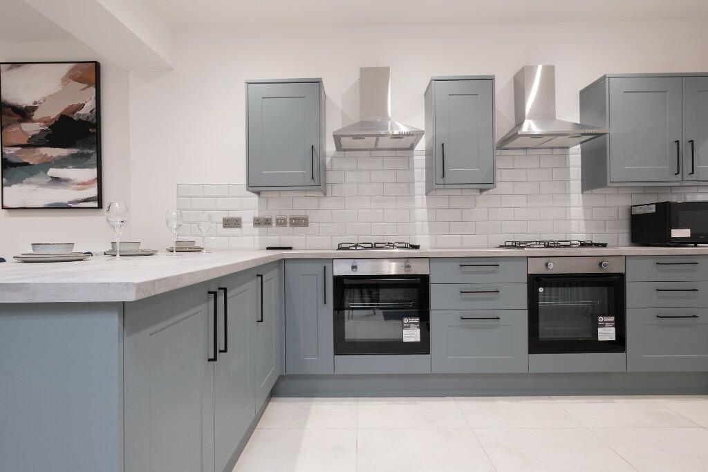 A modern, well-maintained kitchen featuring sle...