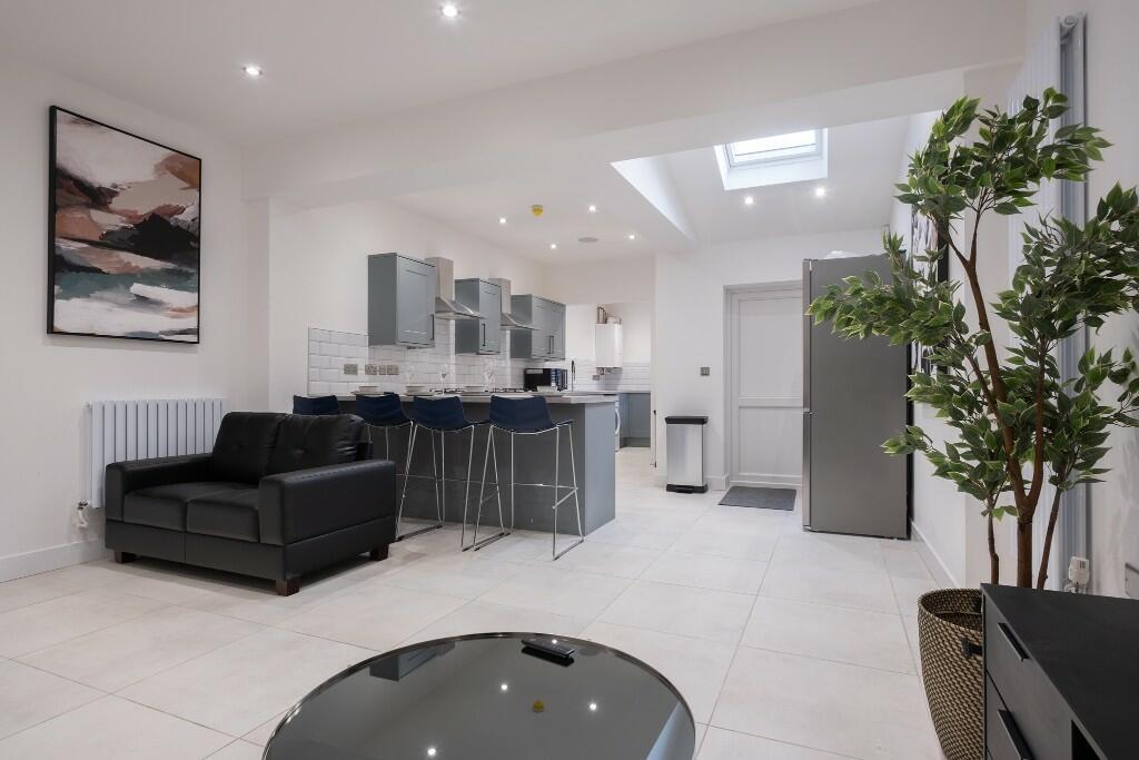 A spacious and modern living room with ample na...