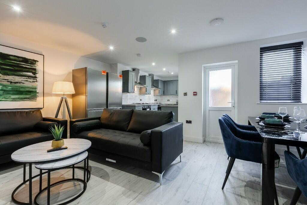 A modern, well-lit living room featuring comfor...