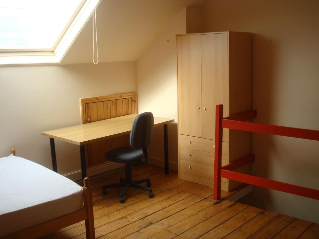 Bright attic bedroom with a large skylight, woo...