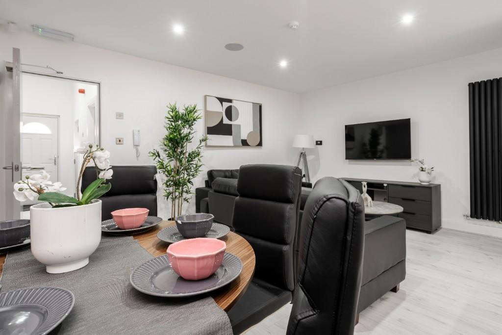 A modern and well-lit living room featuring con...