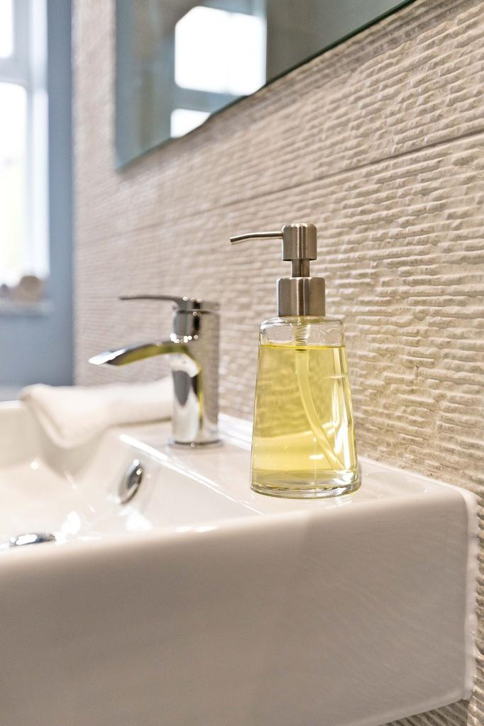 Stylish bathroom sink area with a modern chrome...