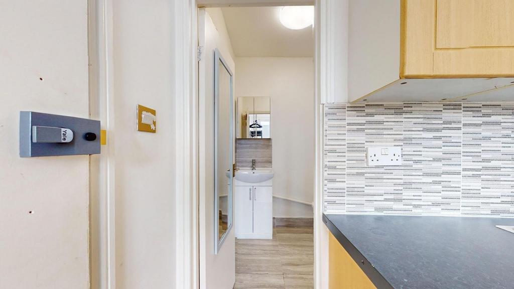 A clean, well-maintained bathroom with a sink a...