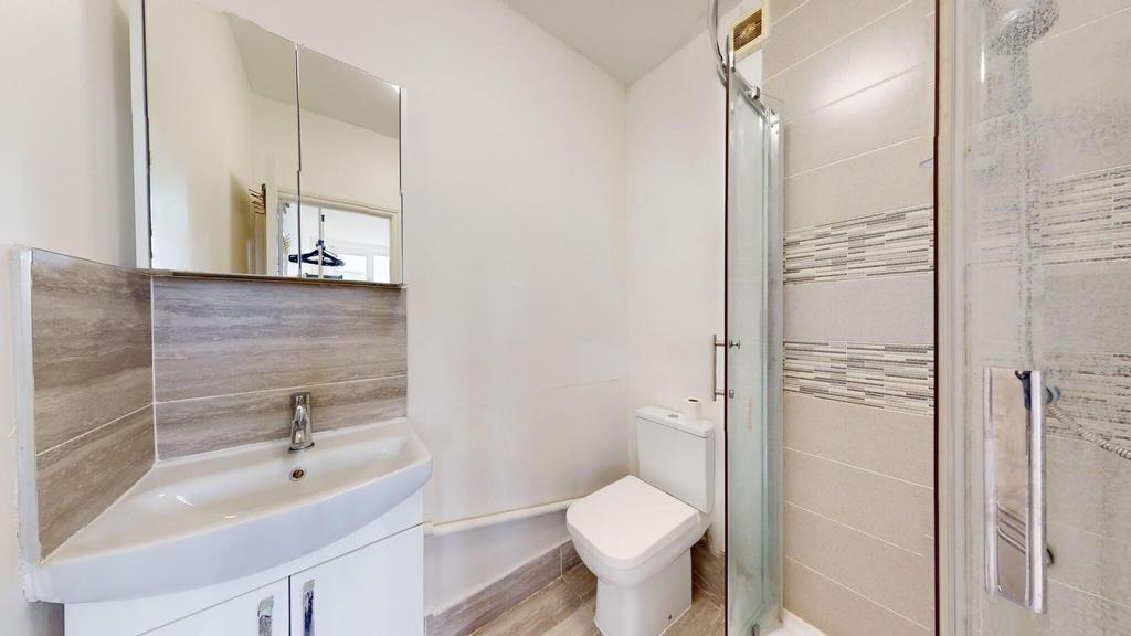 A clean and modern bathroom featuring a compact...