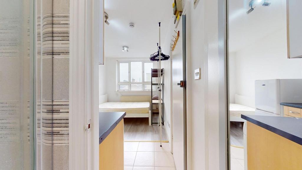 Bright and tidy bedroom with a large window pro...