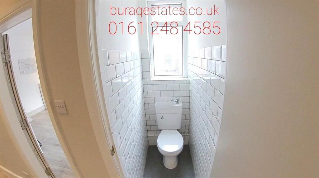 A clean and bright bathroom featuring a standar...