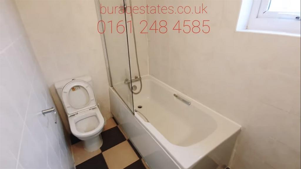 Bright, neutral bathroom with a full-size batht...