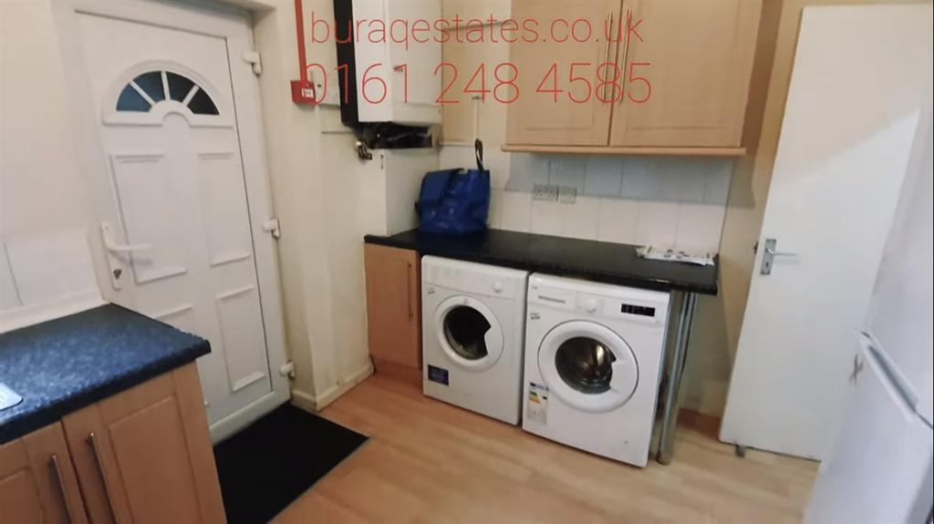 Neat fitted kitchen with integrated laundry app...