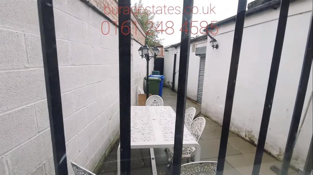 Narrow private courtyard with a small outdoor t...