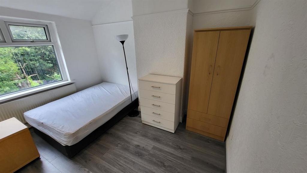 A neatly maintained single bedroom with a bed, ...