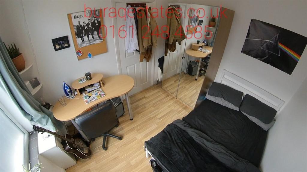 Bright and tidy bedroom with a large bed, desk,...