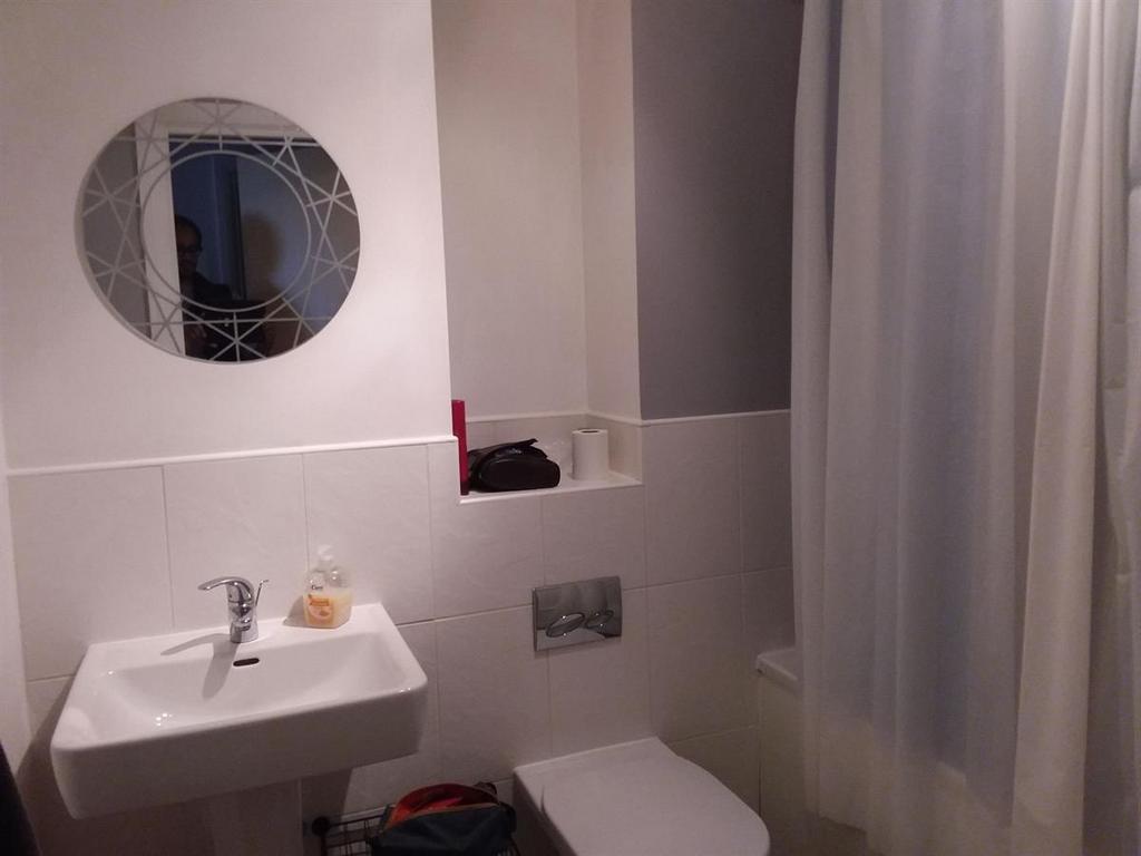 A clean, well-maintained bathroom with a sink, ...