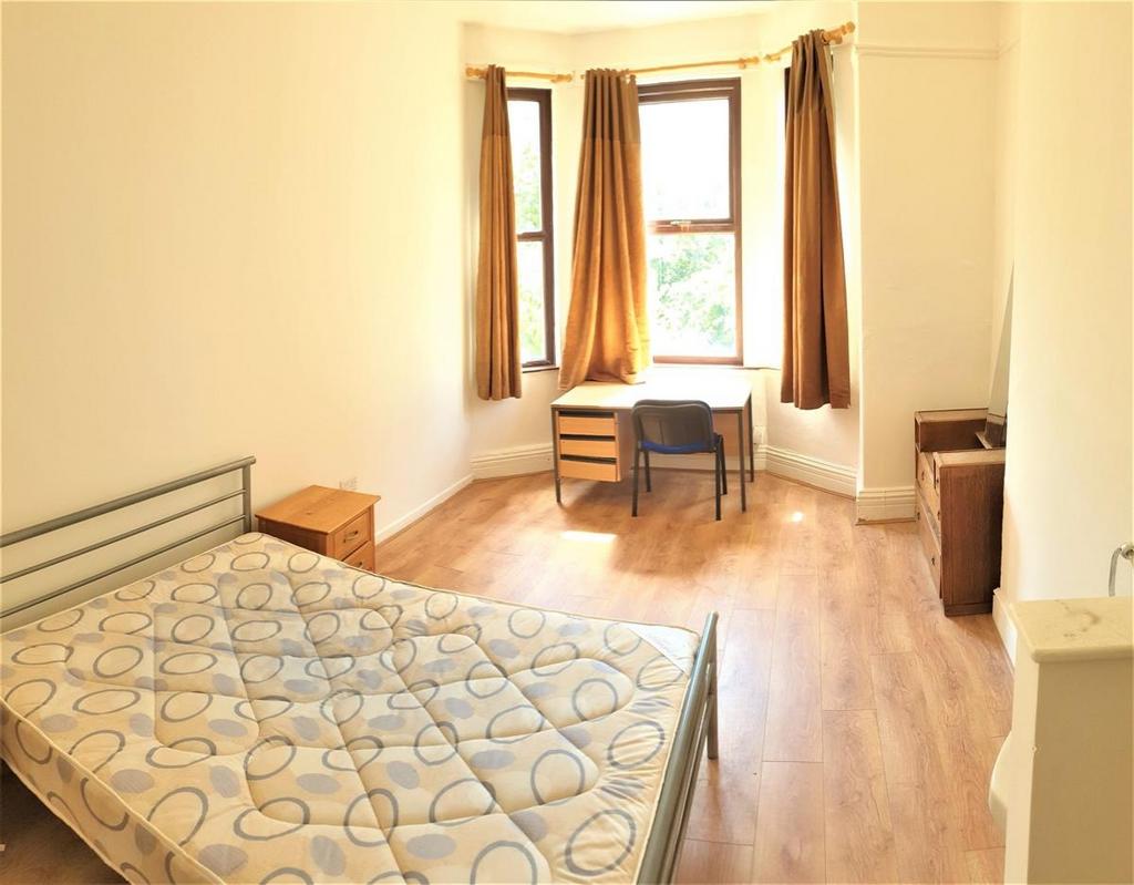 Bright double bedroom with a bay window letting...