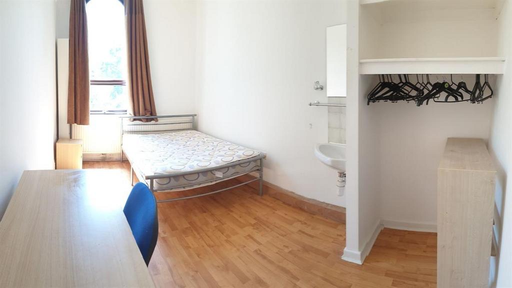 Bright, simply furnished bedroom with a single ...