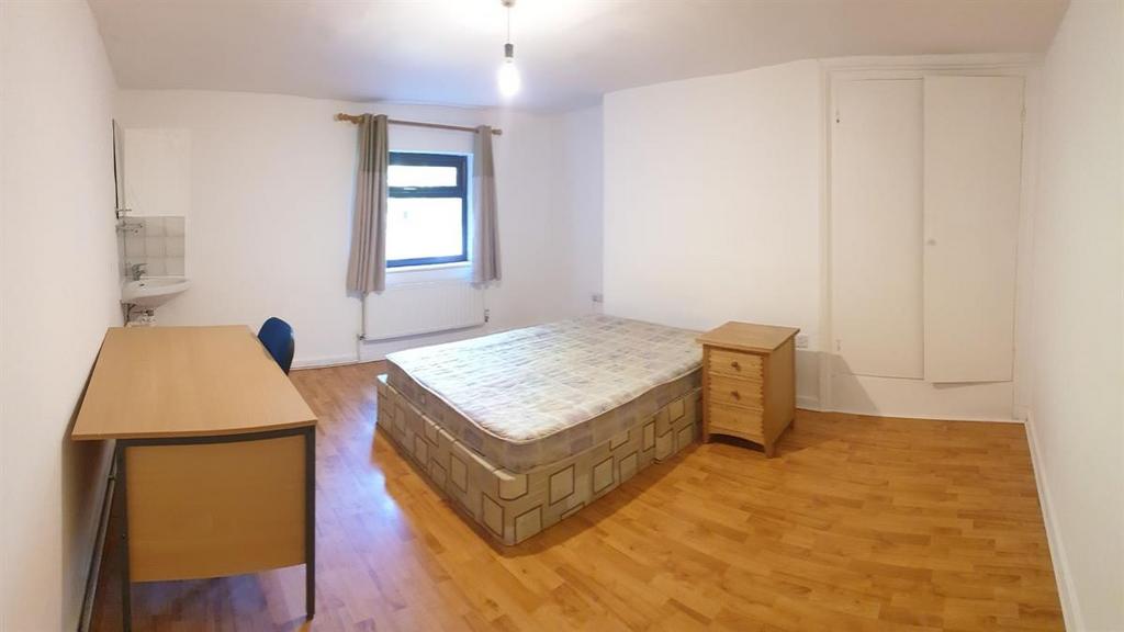 Bright, simply furnished bedroom with a central...
