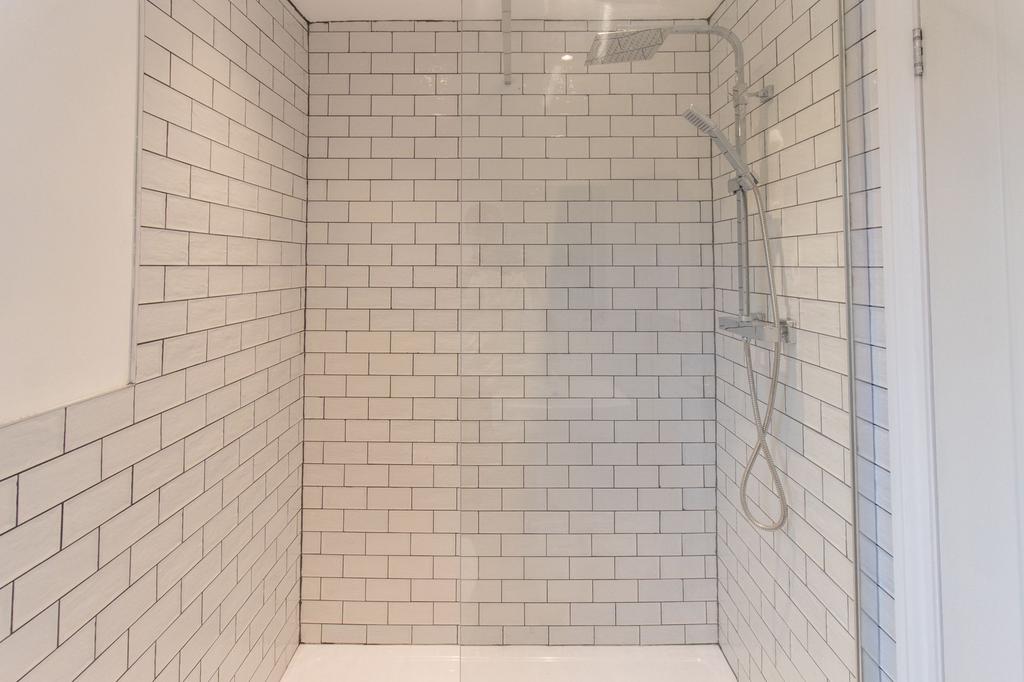 Modern tiled wet-room style shower with subway ...