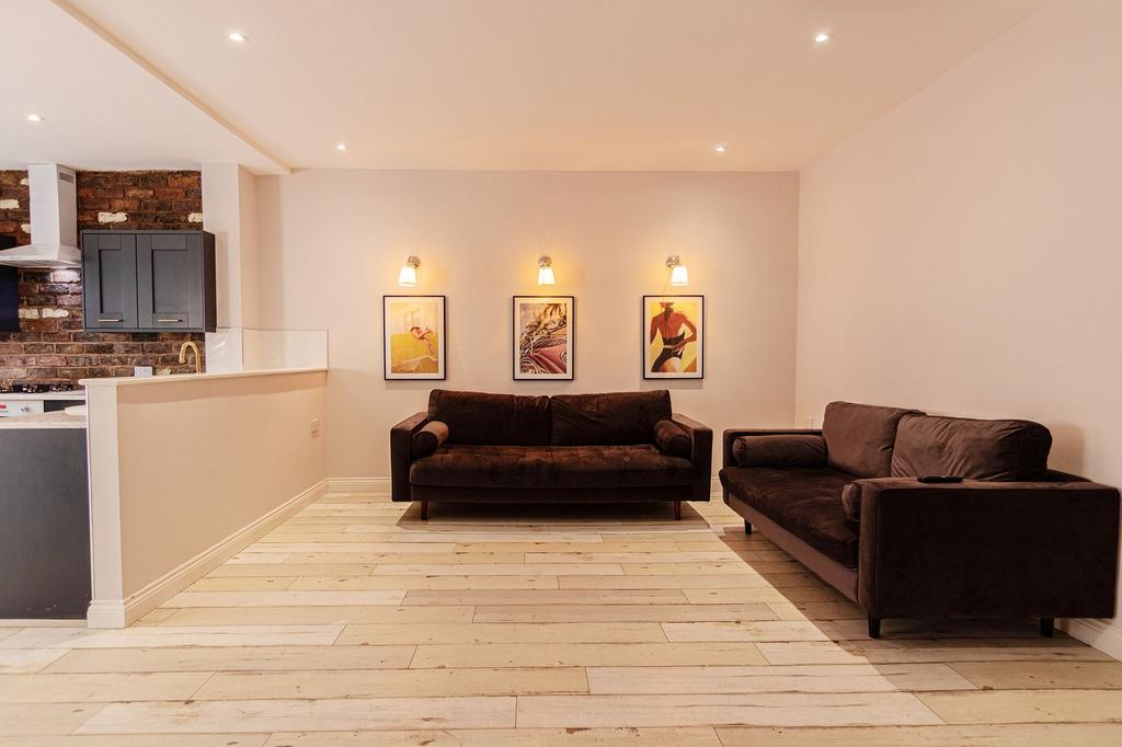 Bright, modern open-plan living area with two c...