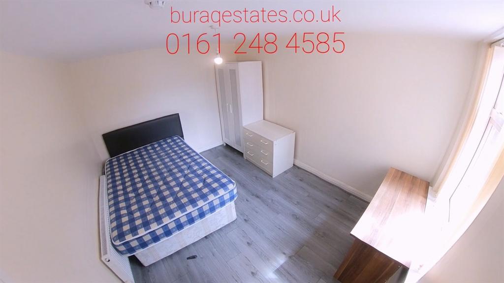 A cozy single bedroom featuring a bed with a ch...