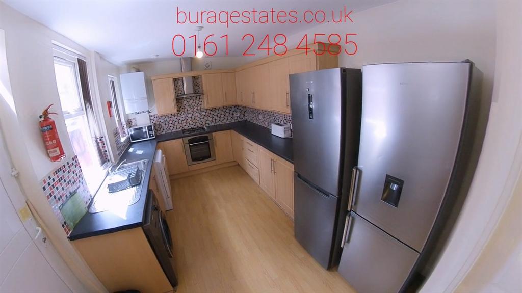 Modern kitchen featuring stainless steel applia...