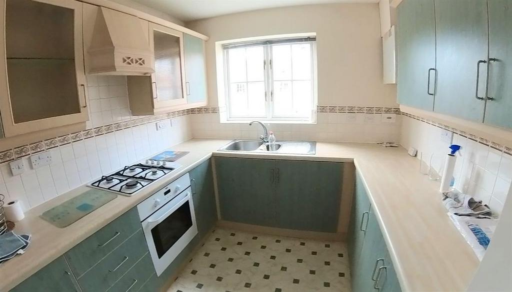 A bright and well-maintained kitchen with ample...