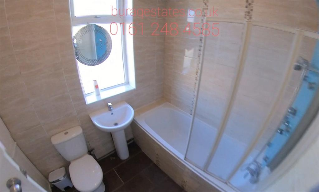 A well-maintained bathroom suite featuring a la...