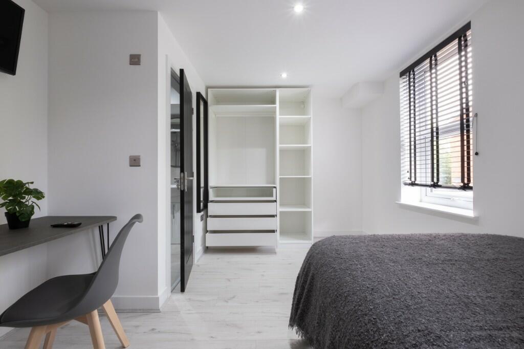 Bright and spacious master bedroom featuring a ...