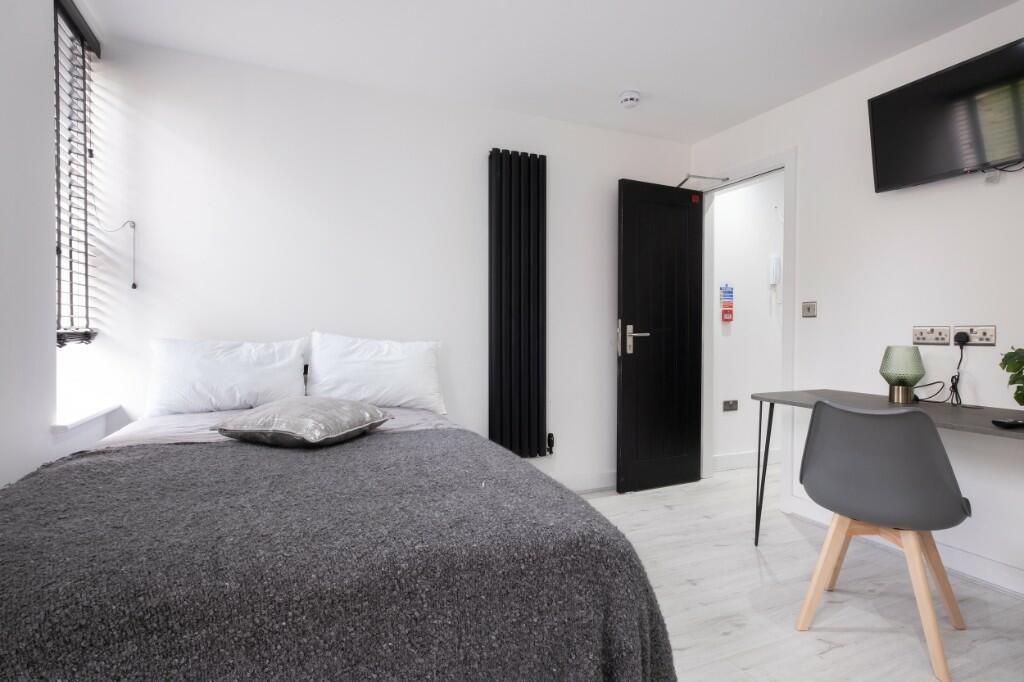 Bright and modern double bedroom featuring a co...