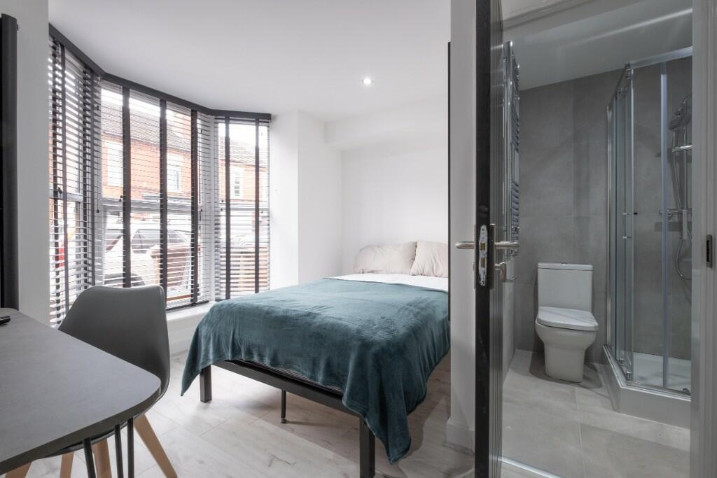 Bright and modern double bedroom featuring a co...